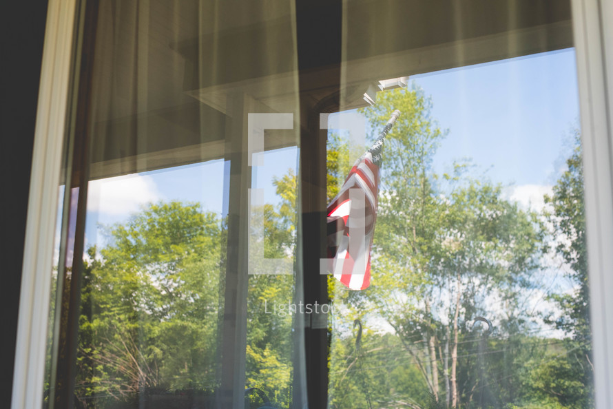 reflection of an American flag in a window 