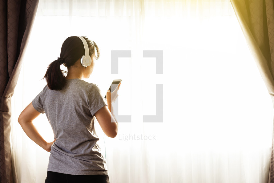 a woman listening to an app on her phone 