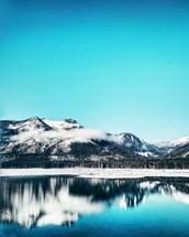 snow covered landscape and mountain lake 