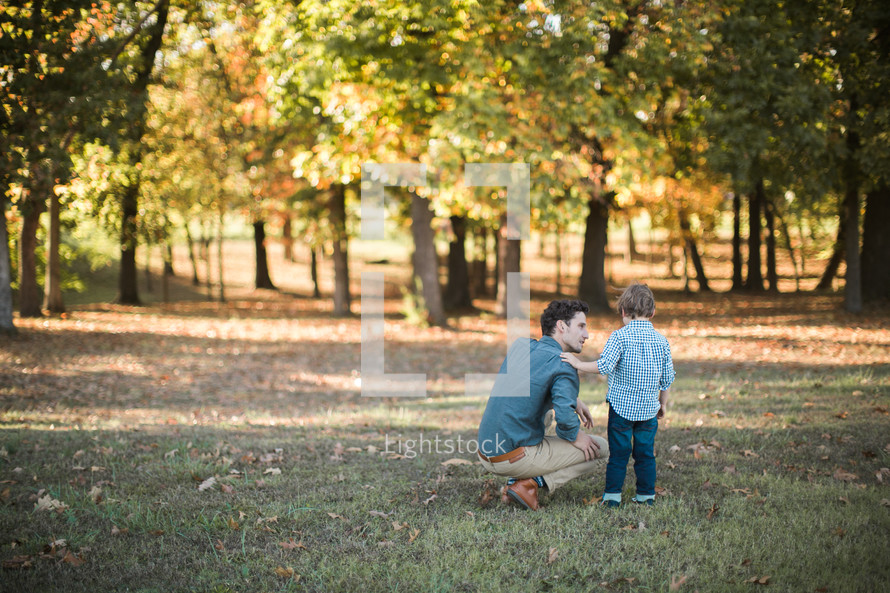 a father and son outdoors in fall 