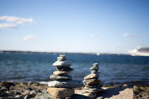 Stacks of rocks on the beach, near the ocean.