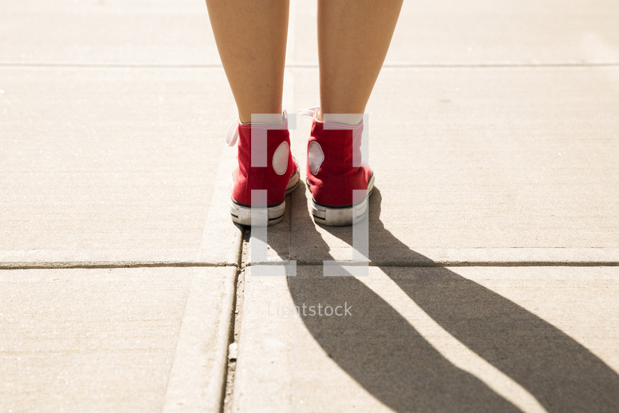 feet in red converse sneakers 