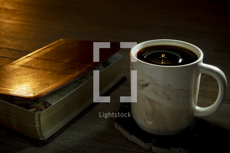 cover of a Bible and coffee mug 