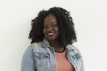 portrait of an African American woman standing in front of a white background 