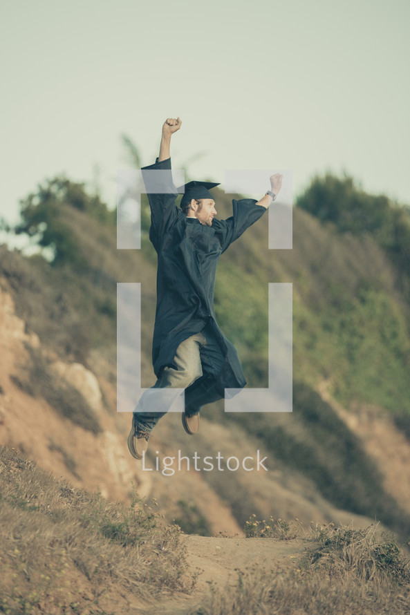 graduate jumping in victory 