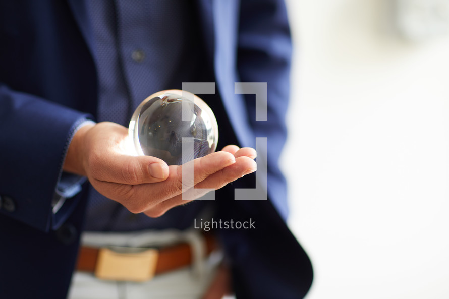 a man holding a crystal ball 