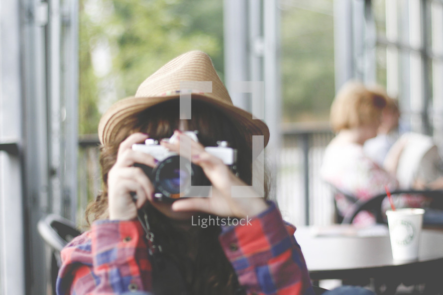 Girl taking picture at coffee shop