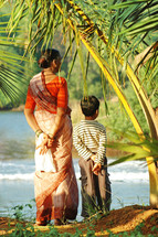 mother and son looking out at a river 