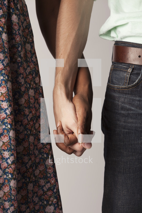 Interracial couple holding hands 