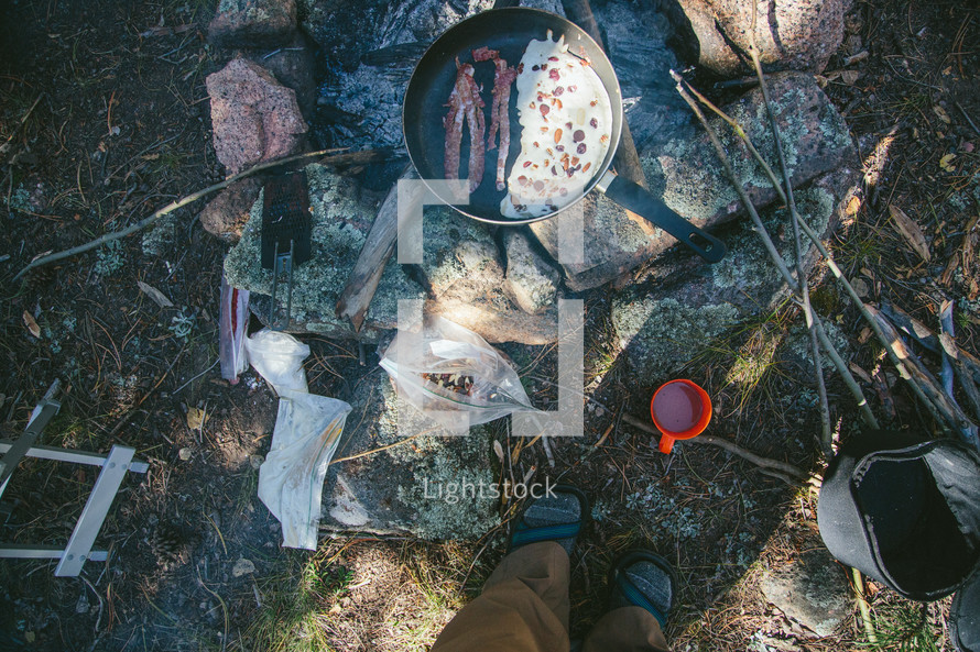 cooking eggs and bacon while camping 