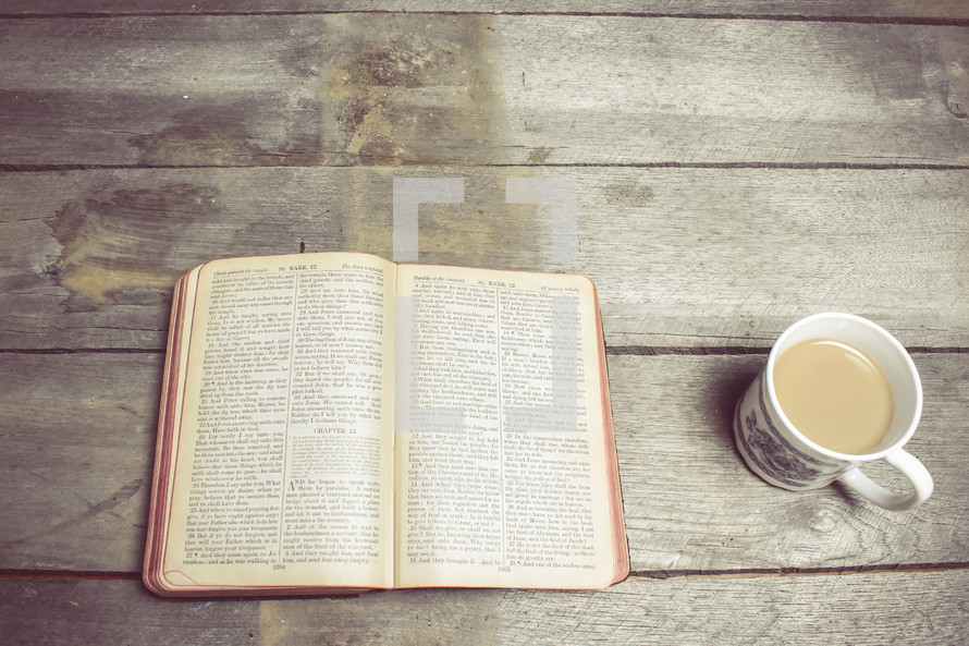pages of a Bible and coffee mug 