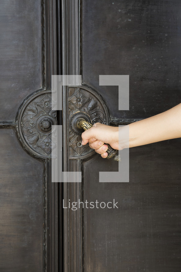 Woman opening a large door.