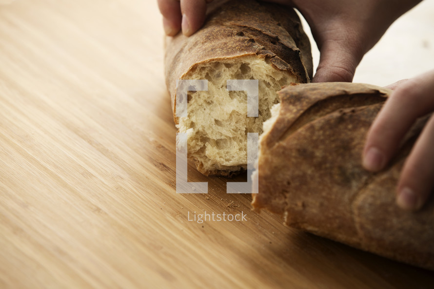 A woman breaking bread