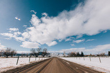 snow and a rural dirt road 