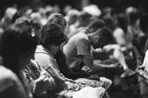 heads bowed in prayer at a worship service 