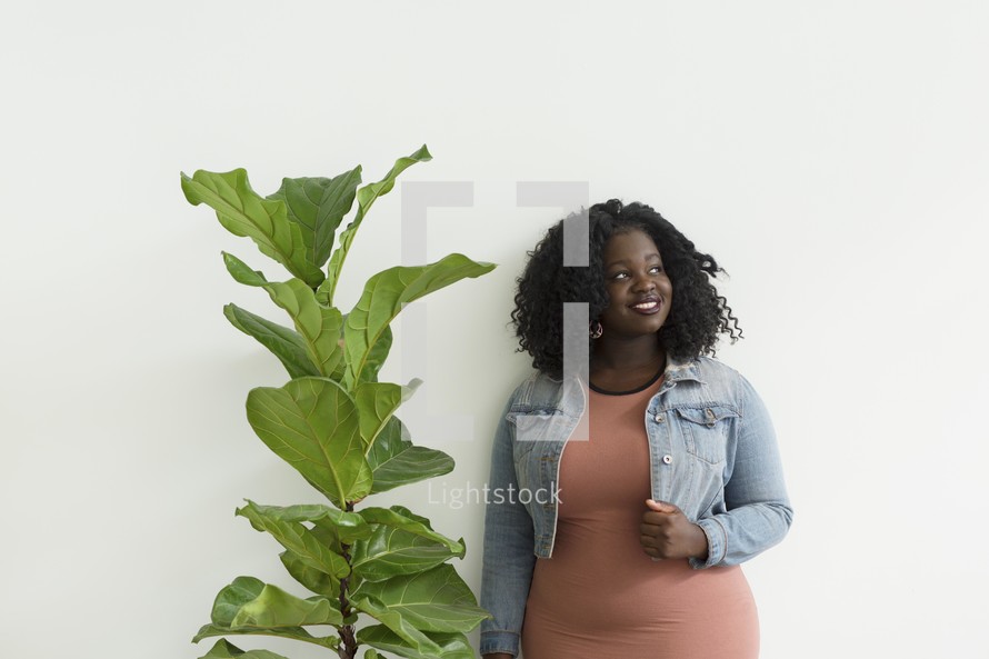 a portrait of an African American woman standing in front of a white background 