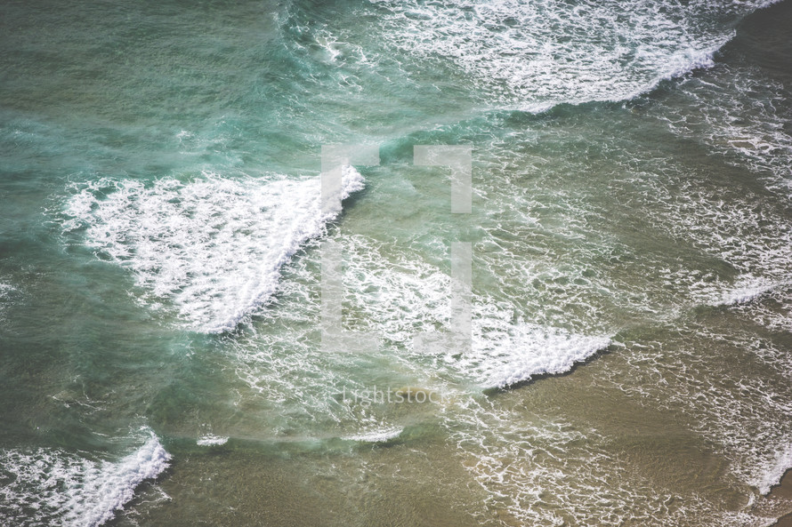 aerial view above waves in the ocean 
