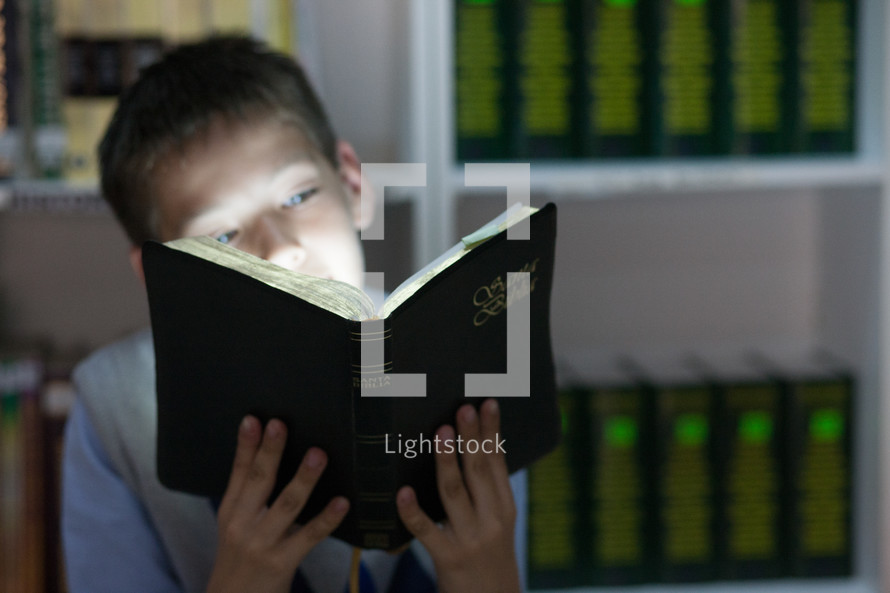 Boy reading the Holy Bible