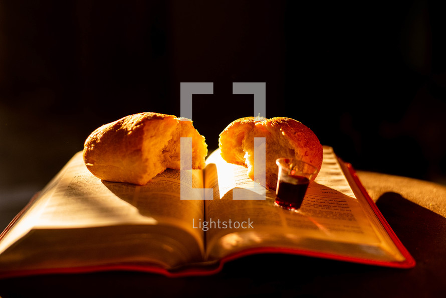 bread and communion cup on a Bible 