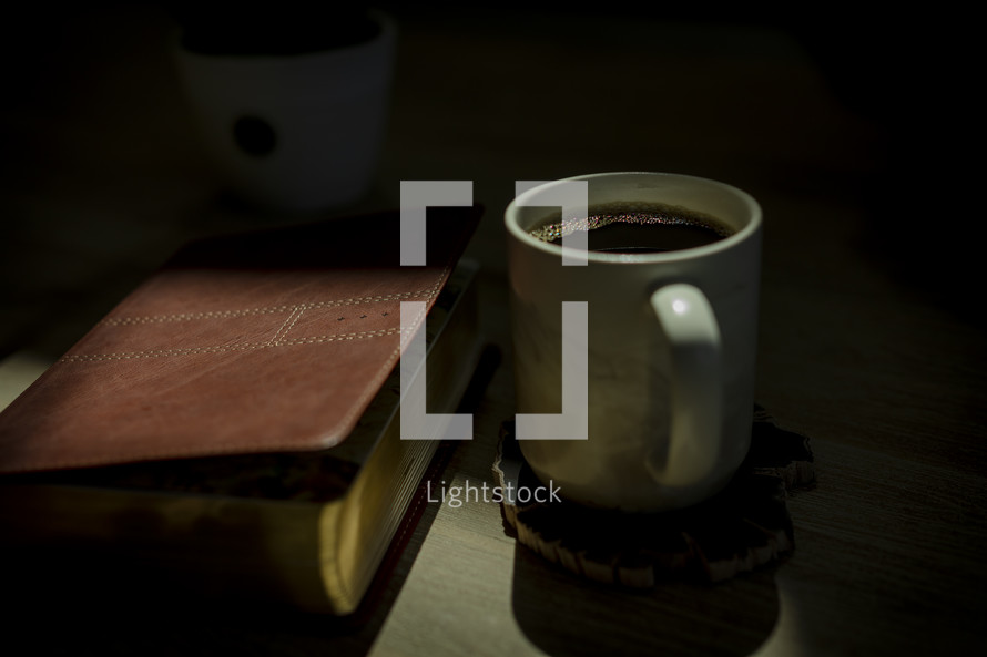 cover of a Bible and coffee mug 