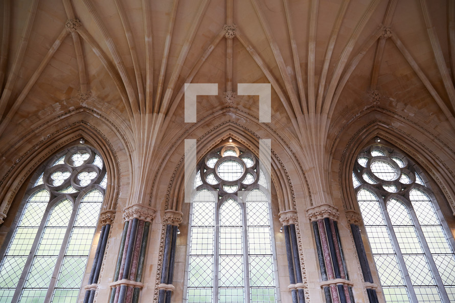 tall arched windows and ornate ceiling in a cathedral 