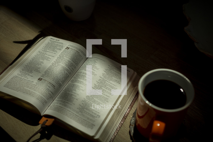 opened Bible and coffee mug 