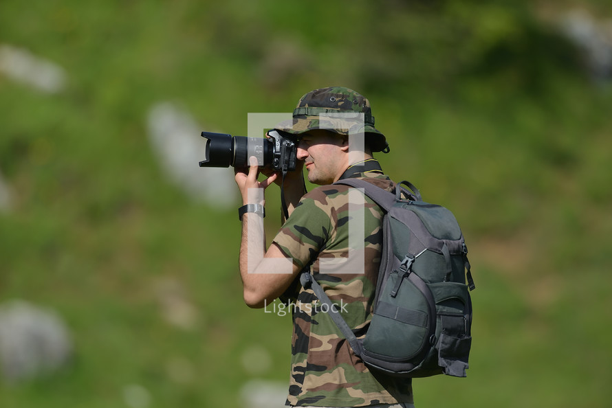 wildlife photographer in camouflage 