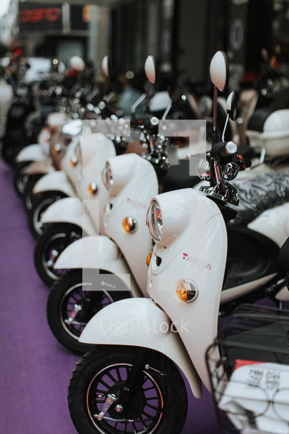 row of white scooters 
