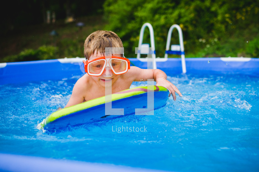 a little boy in a swimming pool 