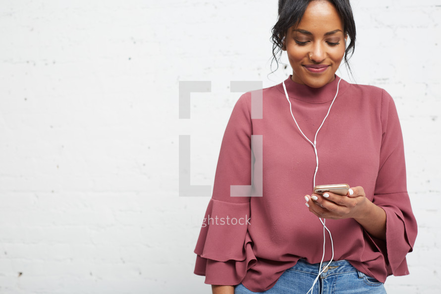African American woman listening to a podcast 