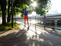 Man jogging on a path in the harbor.