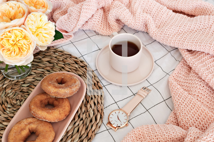 vase, donuts, mat, scarf, watch, and coffee 