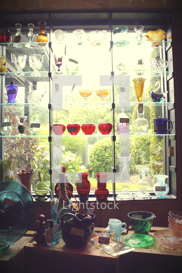 glass bowls and vases in a store window