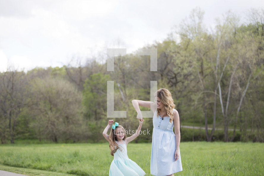 mother twirling her daughter 