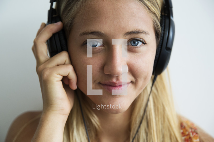 a teen girl listening to headphones 