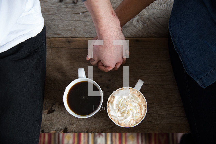 mugs of coffee and a couple holding hands 