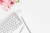 pink flowers, pencils, computer keyboard, and paperclips 