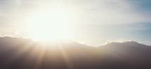 sunburst over a mountain 
