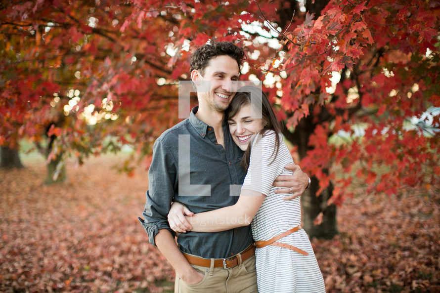 a couple hugging outdoors in fall 