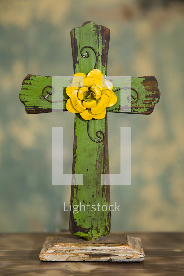 a green an yellow wooden cross 