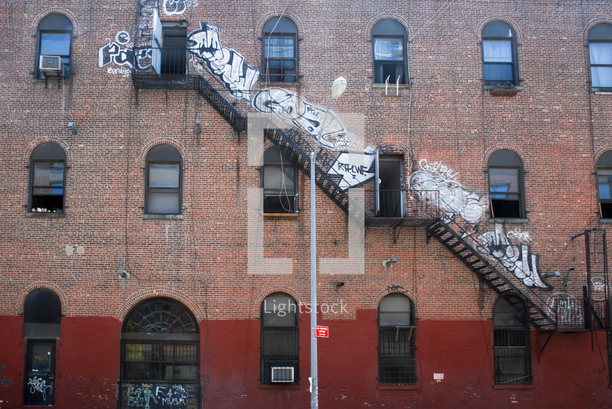 grafitti and fire escape on a brick building in New York City 