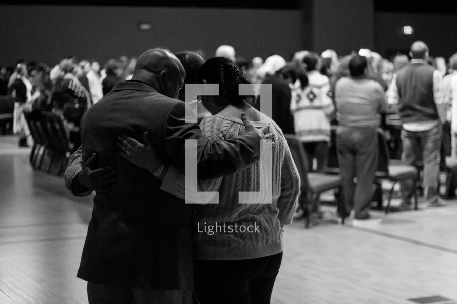 hugs of prayer at a worship service