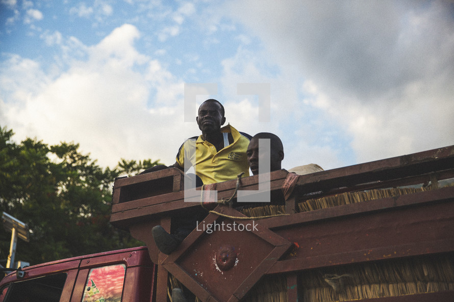 Men in a truck bed.