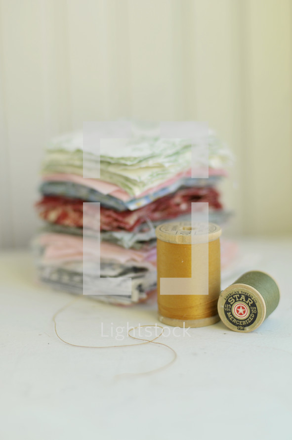 stack of fabric and thread 