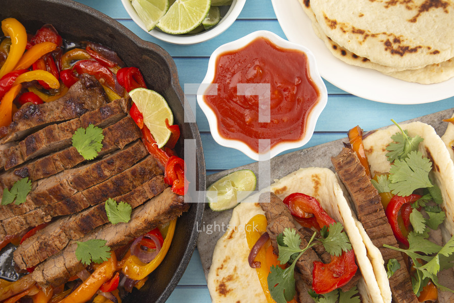 Beef Fajitas with Bell Peppers on a Bright Blue Wood Table