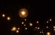 hanging glowing lightbulbs in darkness 