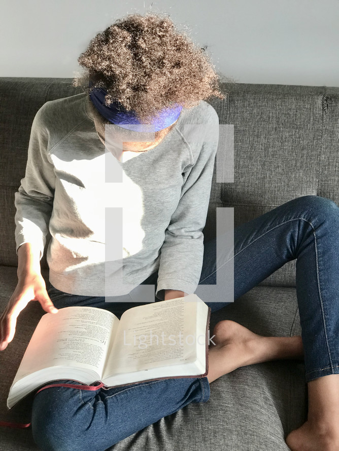 teen girl reading a Bible 