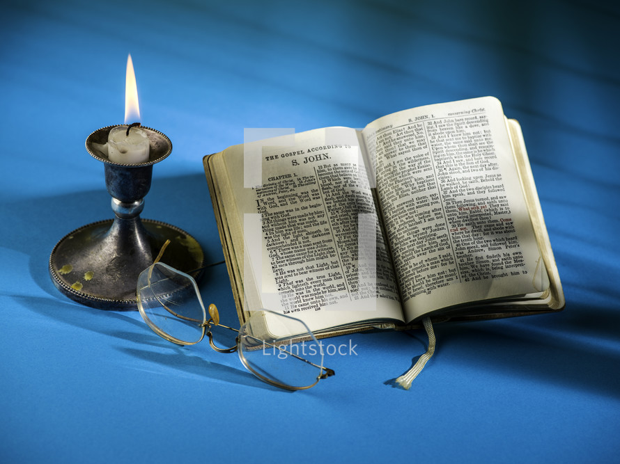 candlestick and open Bible 