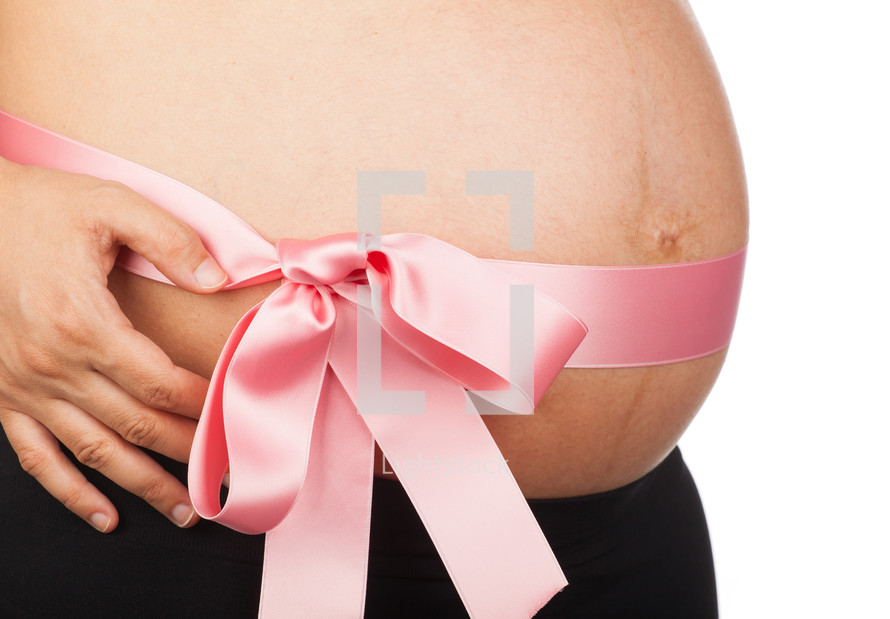 Belly of a pregnant woman on white background
