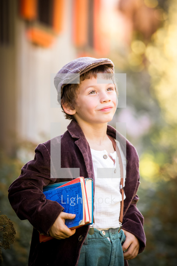 a boy holding books 